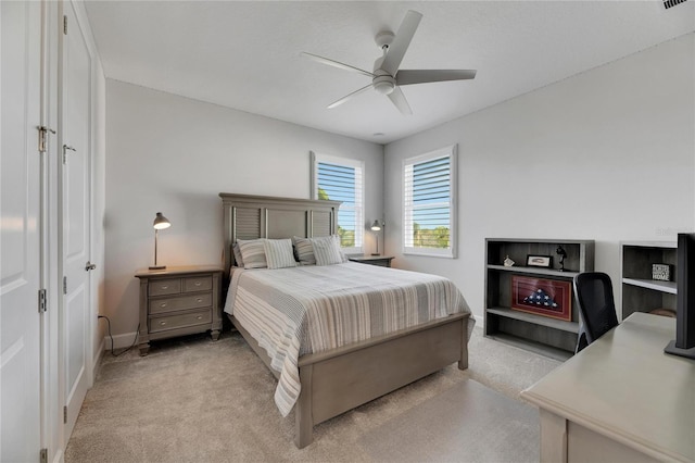 bedroom featuring light colored carpet and ceiling fan