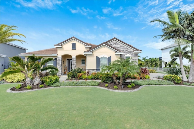 mediterranean / spanish-style home featuring a front yard