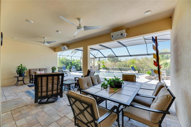 view of patio / terrace featuring ceiling fan, outdoor lounge area, and glass enclosure