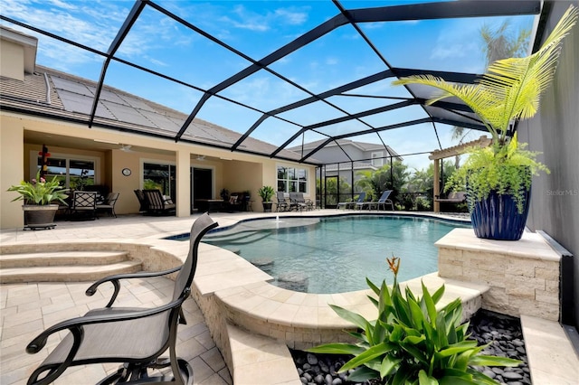 view of pool with glass enclosure and a patio area