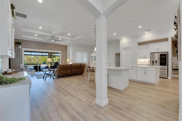 kitchen featuring stainless steel refrigerator, coffered ceiling, white cabinets, a kitchen island, and beamed ceiling