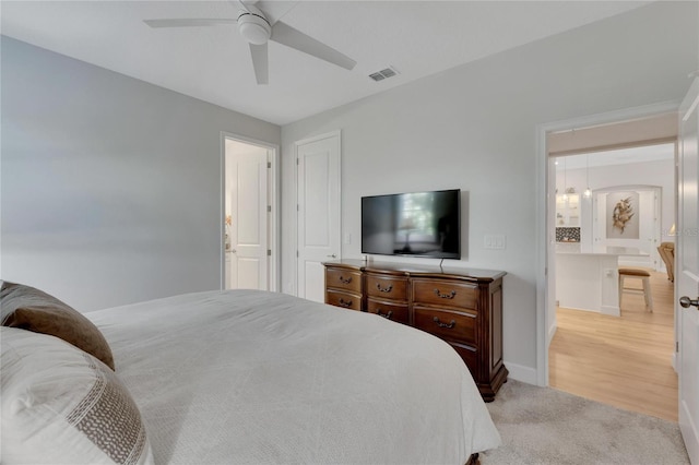 bedroom with light colored carpet and ceiling fan