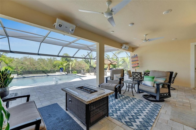 view of patio / terrace with an outdoor living space with a fire pit, pool water feature, ceiling fan, and glass enclosure