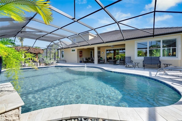 view of swimming pool with a lanai, a patio area, and ceiling fan