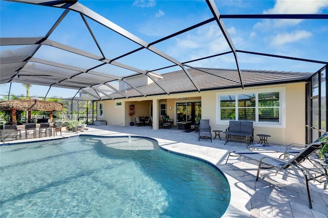 view of swimming pool with a patio and glass enclosure