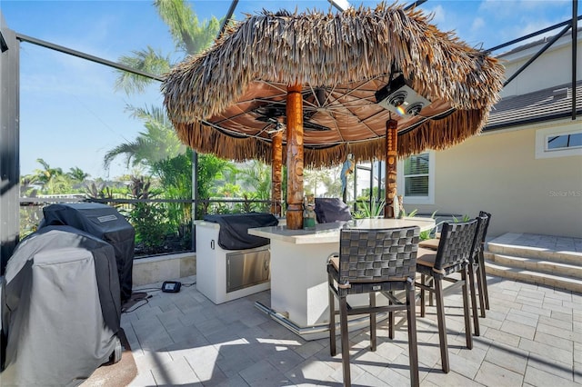 view of patio / terrace with area for grilling and a bar