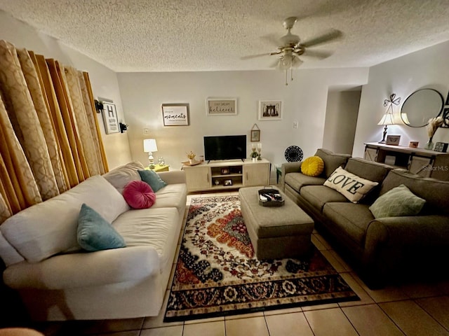 tiled living room with ceiling fan and a textured ceiling