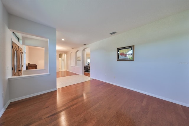 empty room with hardwood / wood-style flooring