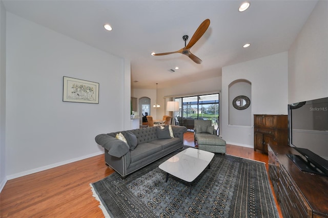 living room featuring ceiling fan and hardwood / wood-style floors