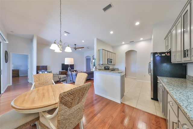 dining area with light hardwood / wood-style floors and a chandelier