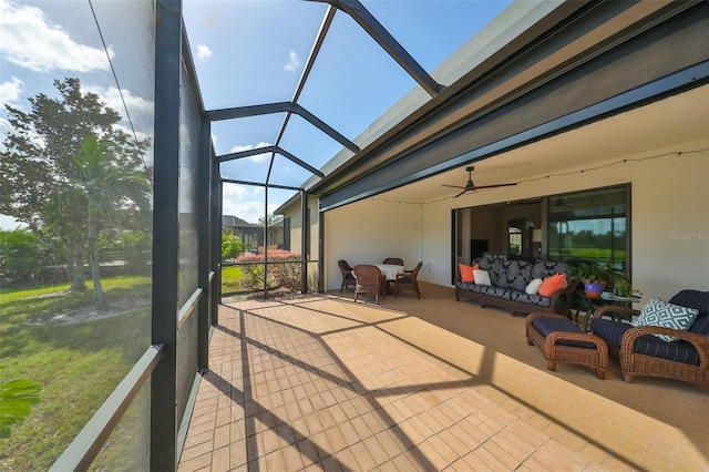 sunroom / solarium featuring ceiling fan