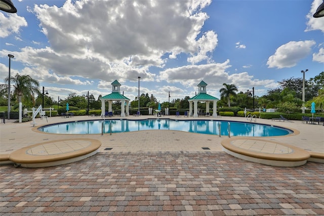 view of swimming pool with a gazebo and a patio area