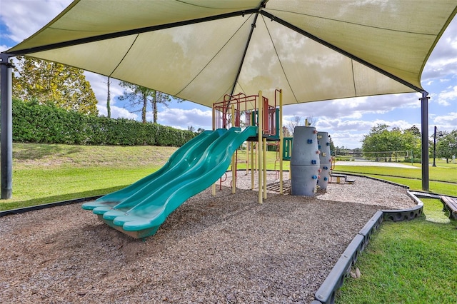 view of jungle gym featuring a lawn