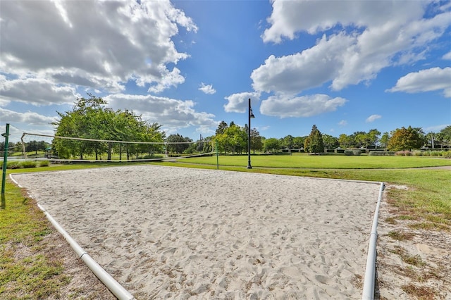 view of community featuring a lawn and volleyball court