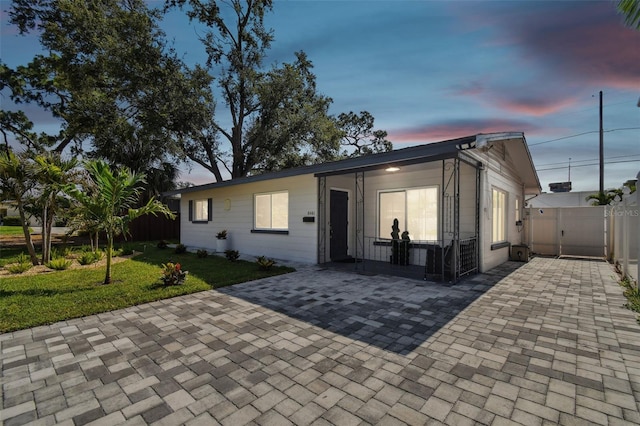 view of front of house featuring a yard and a patio area