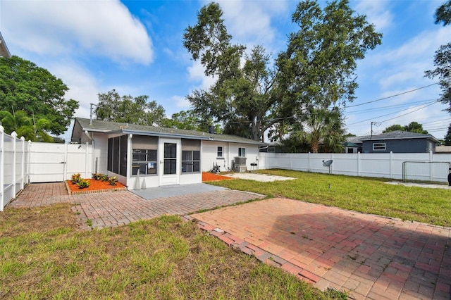 back of house with a patio, a sunroom, and a yard