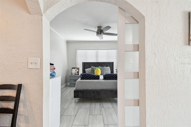 bedroom featuring ornamental molding and ceiling fan