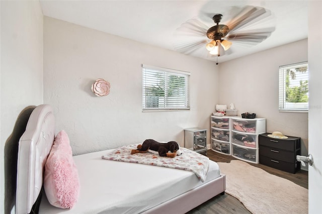 bedroom with ceiling fan and dark hardwood / wood-style flooring