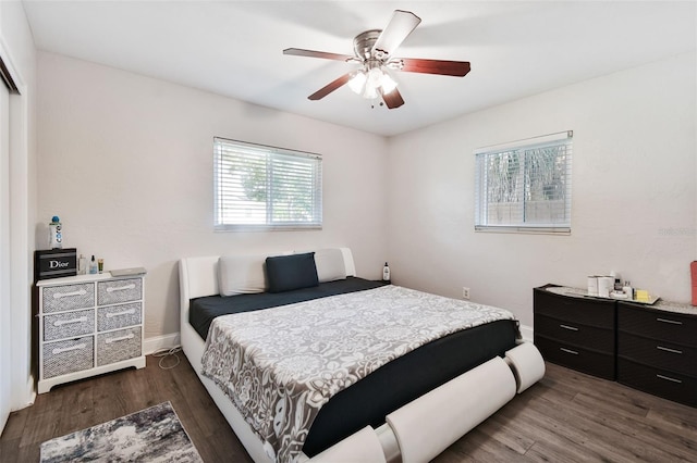 bedroom with dark wood-type flooring and ceiling fan