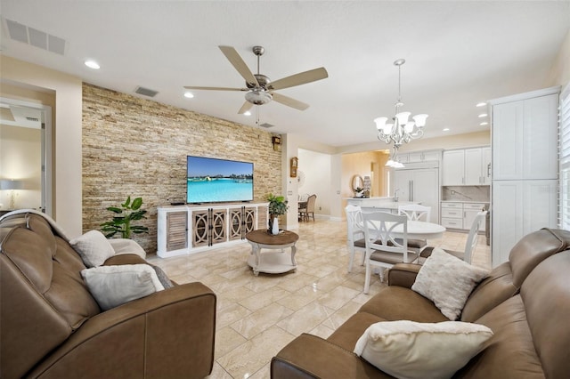 living room featuring ceiling fan with notable chandelier