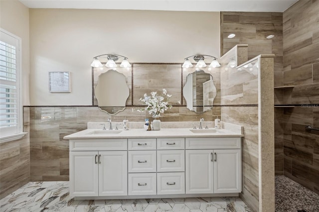 bathroom featuring tile walls, tiled shower, a healthy amount of sunlight, and vanity