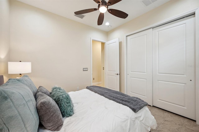 tiled bedroom featuring ceiling fan and a closet