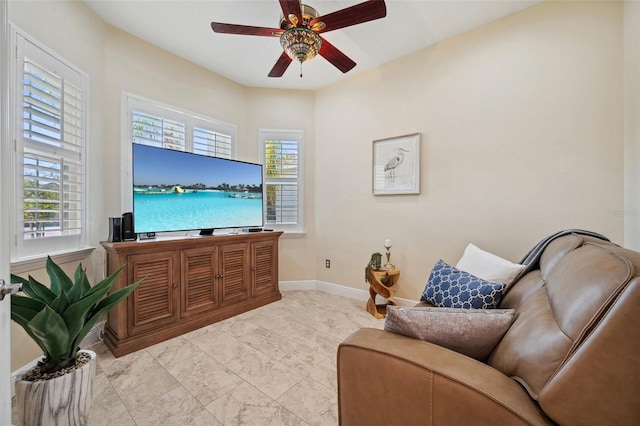 living room featuring a healthy amount of sunlight and ceiling fan