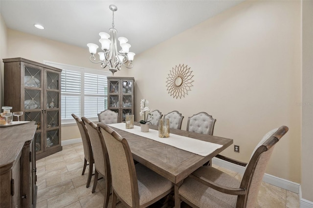 dining space with an inviting chandelier