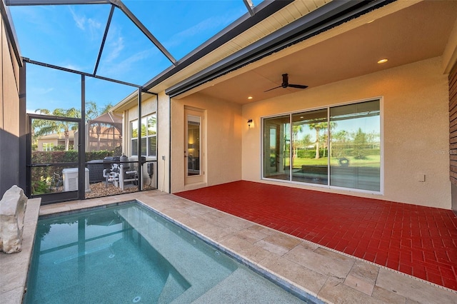 view of swimming pool with a patio, ceiling fan, and a lanai