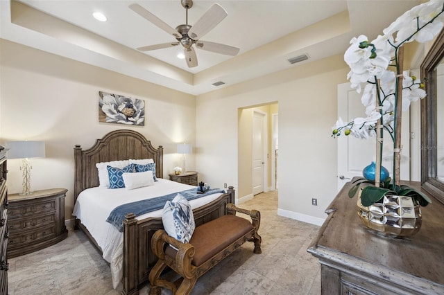 bedroom featuring ceiling fan and a tray ceiling