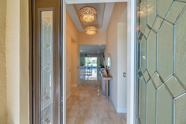 foyer entrance with light tile patterned floors and a chandelier