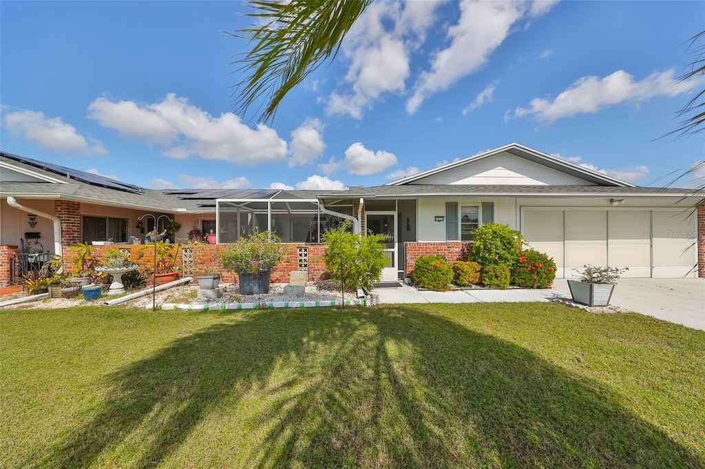 single story home featuring a front yard and a garage