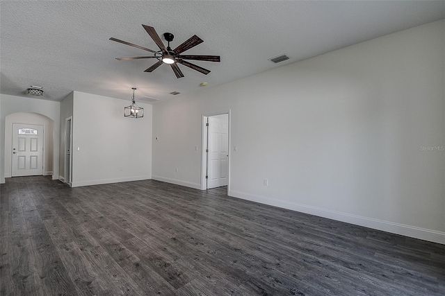 empty room with dark hardwood / wood-style floors, a textured ceiling, and ceiling fan