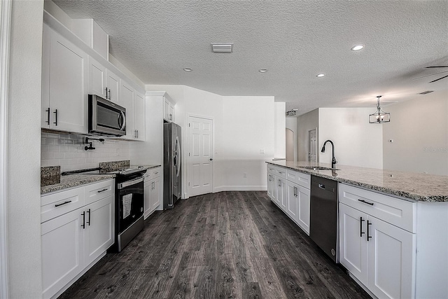 kitchen featuring appliances with stainless steel finishes, dark hardwood / wood-style floors, and white cabinetry