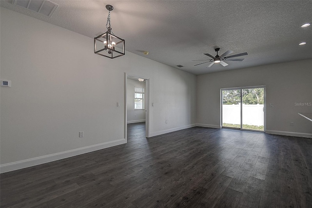 unfurnished room with a textured ceiling, ceiling fan with notable chandelier, and dark hardwood / wood-style flooring