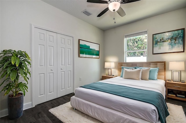 bedroom with dark hardwood / wood-style flooring, a closet, and ceiling fan