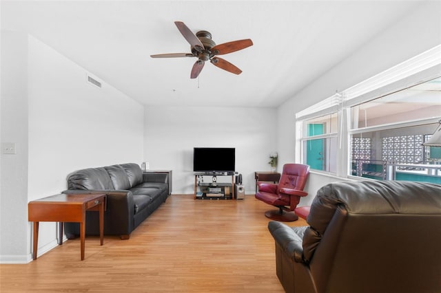 living room with ceiling fan and light wood-type flooring