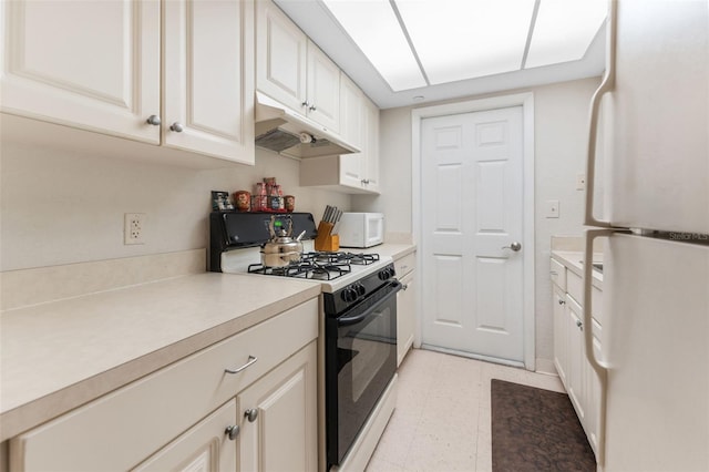 kitchen featuring white appliances and white cabinetry