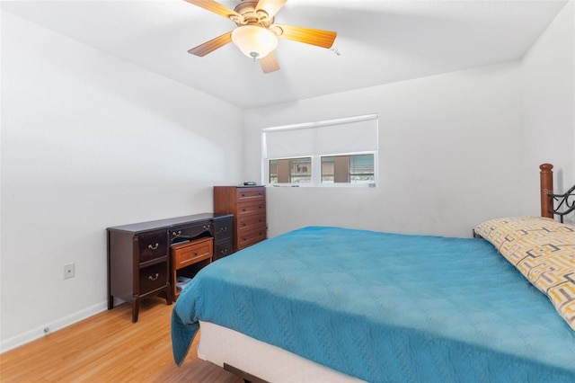 bedroom with ceiling fan and hardwood / wood-style floors