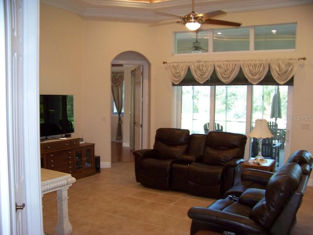 tiled living room with crown molding and ceiling fan