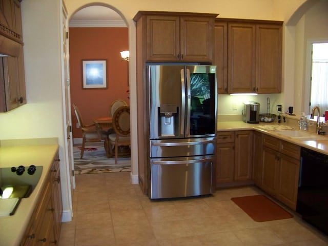 kitchen with dishwasher, stainless steel refrigerator with ice dispenser, ornamental molding, sink, and light tile patterned floors