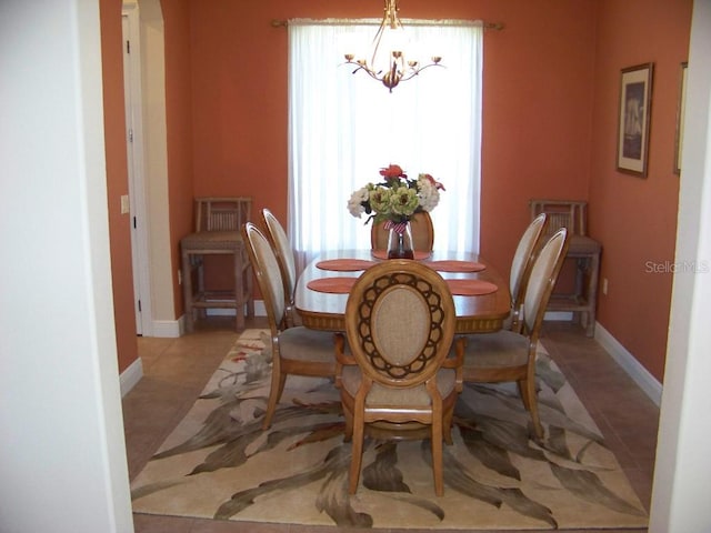 dining space featuring an inviting chandelier and light tile patterned floors