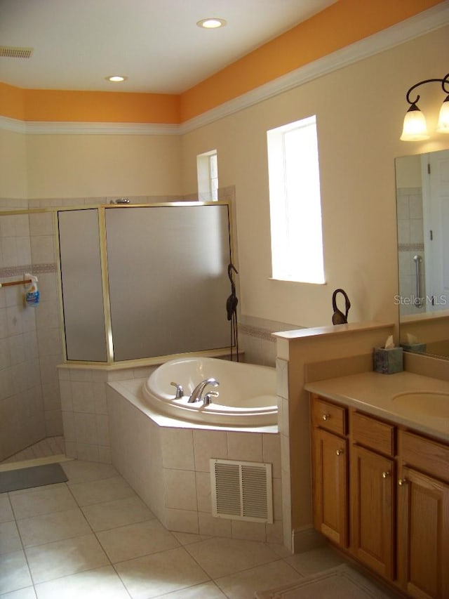 bathroom featuring vanity, independent shower and bath, and tile patterned flooring