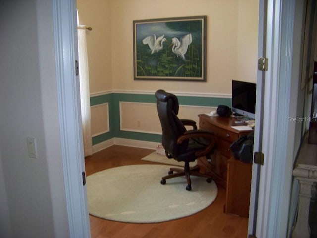 home office with wood-type flooring