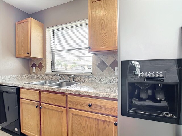 kitchen featuring dishwasher, backsplash, light brown cabinets, and sink