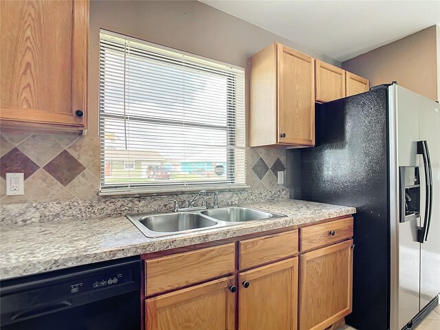 kitchen with dishwasher, stainless steel refrigerator with ice dispenser, sink, tasteful backsplash, and light brown cabinets