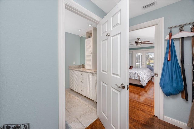 bathroom with vanity, wood-type flooring, and ceiling fan