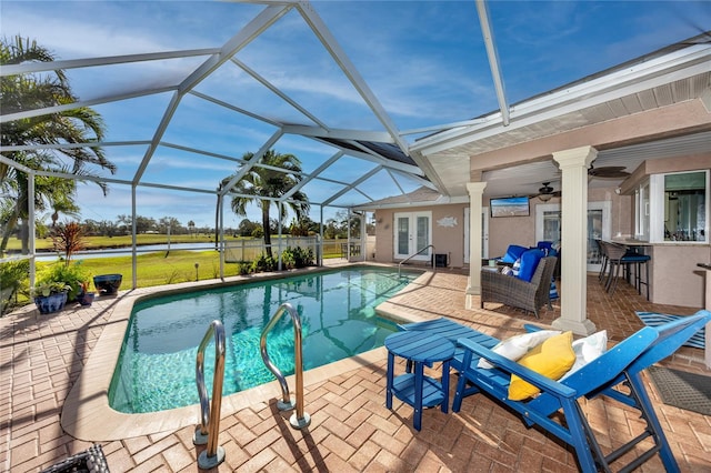 view of pool with a lanai, an outdoor living space, a patio, and ceiling fan