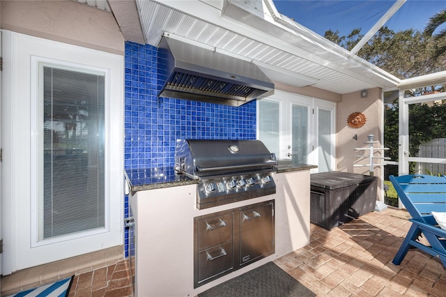 view of patio / terrace with french doors, exterior kitchen, and a grill