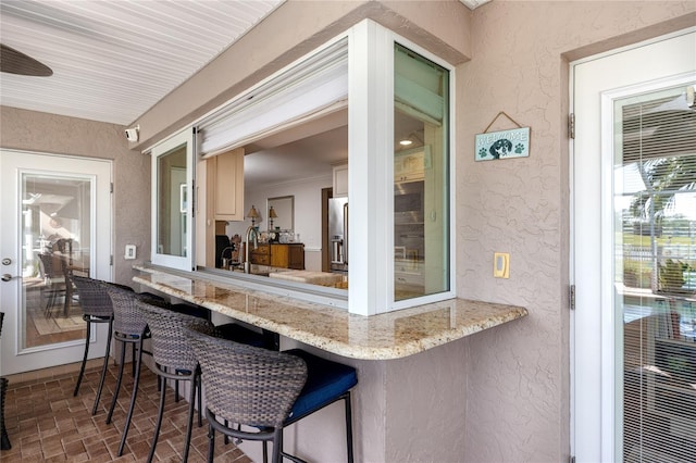 exterior space featuring a wet bar and ceiling fan